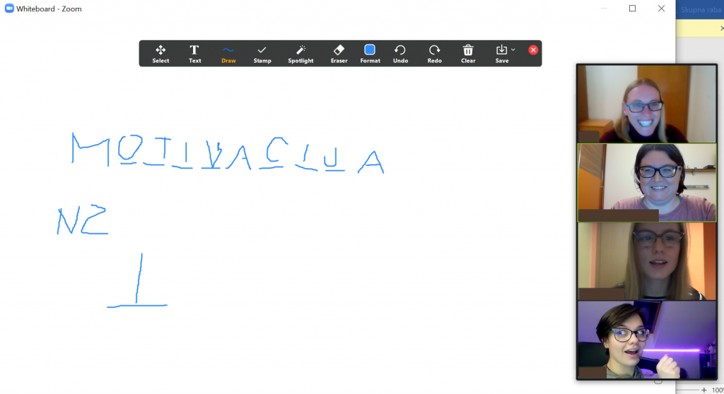 Igranje vislic preko Zooma, izpisana je beseda motivacija