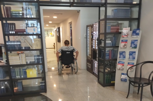 Udeleženka se z invalidskim vozičkom pelje na klančino